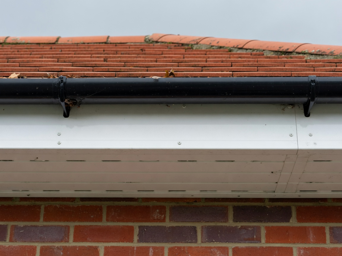 White uPVC fascia, soffit and black gutter on a tiled roof